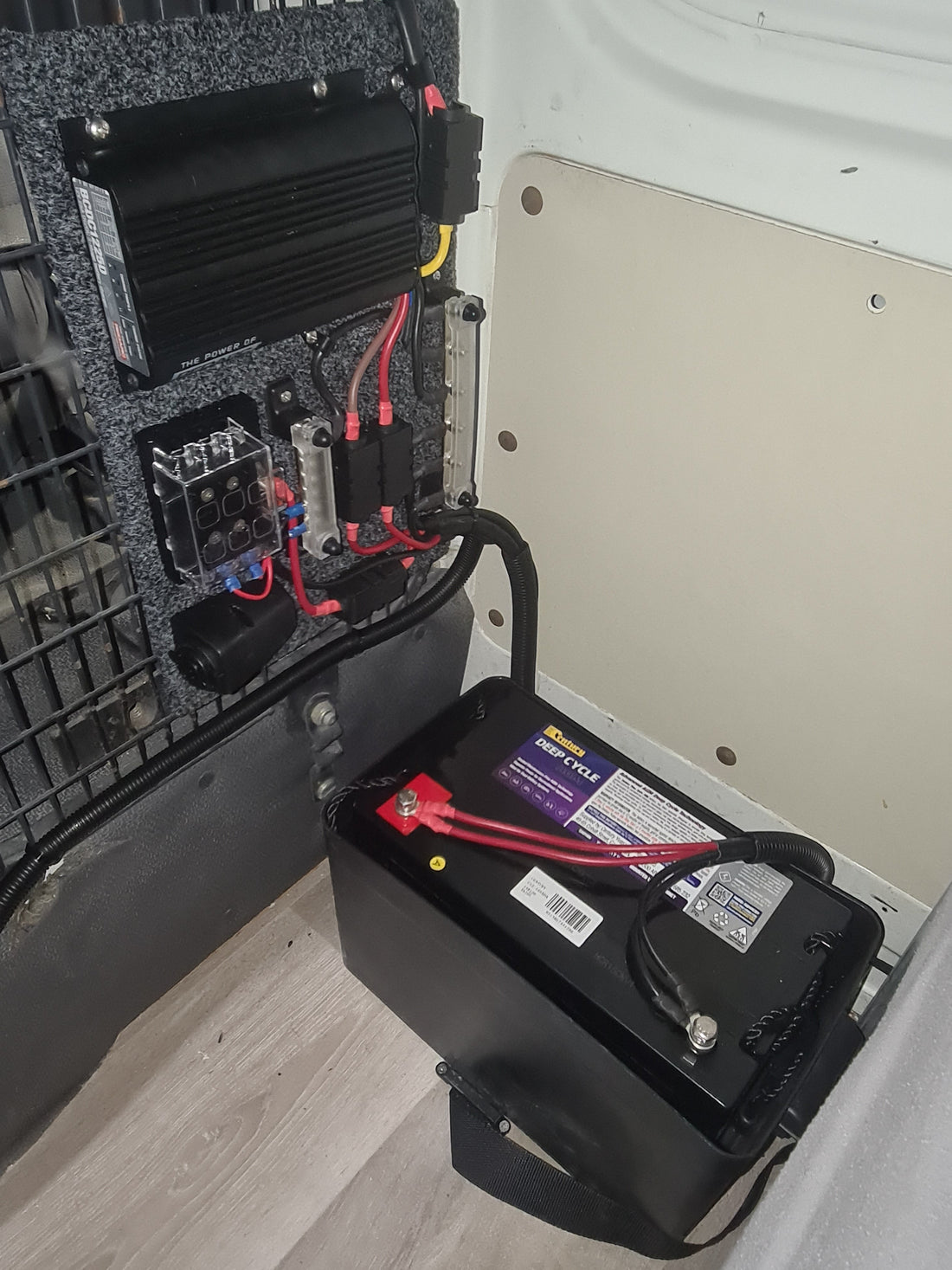 Century deep cycle battery installed with a DC charger and fuse panel