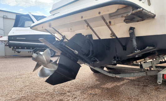 Cruiser on the hardstand with fresh black antifoul below the waterline and a serviced sterndrive