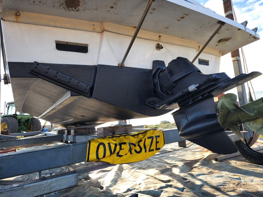 Cruiser on the hardstand showing transom, sterndrive and propeller from underneath