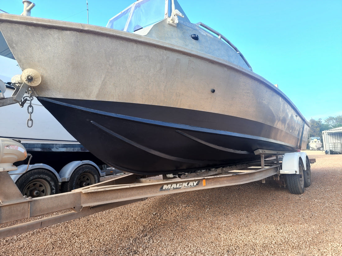Plate aluminium fishing boat on its trailer at the yard between seasons