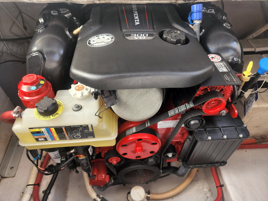 Twin outboards mounted on a vessel's transom at the workshop