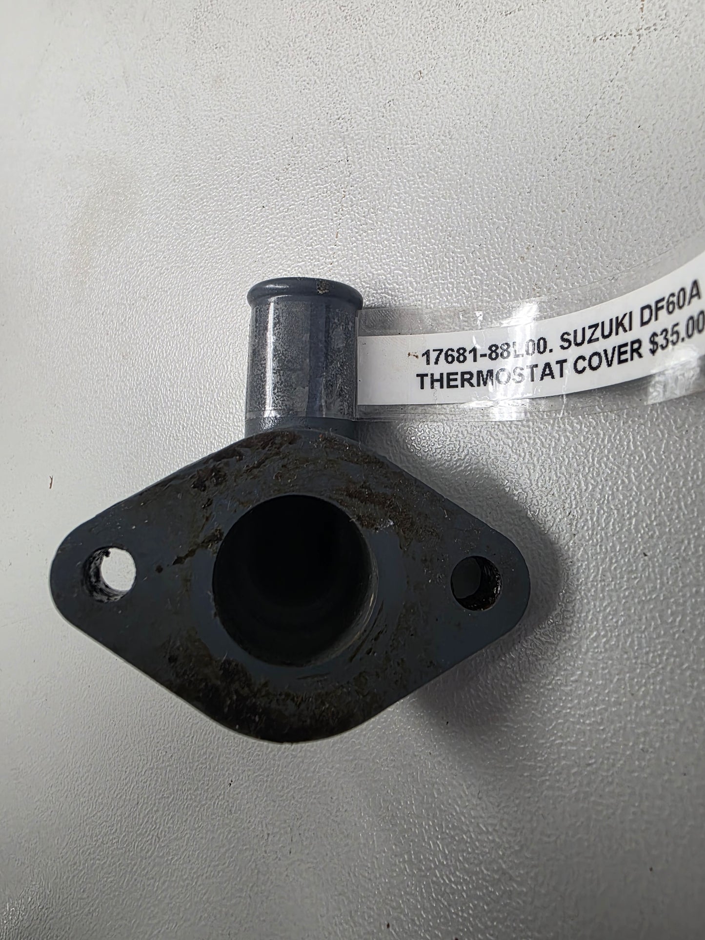 17681-88L00 Suzuki DF60A Thermostat Cover | Genuine Used Part